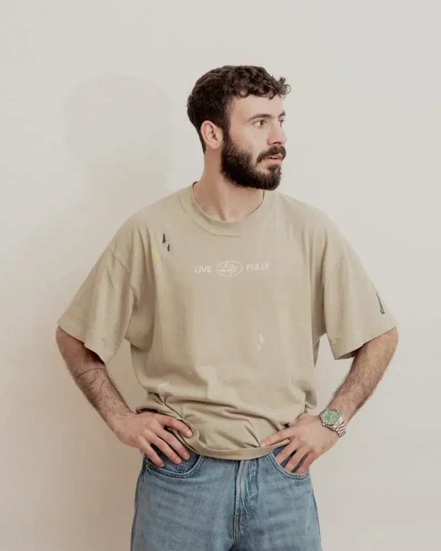 Kevo Emerezian, hands on hips, in a beige t-shirt